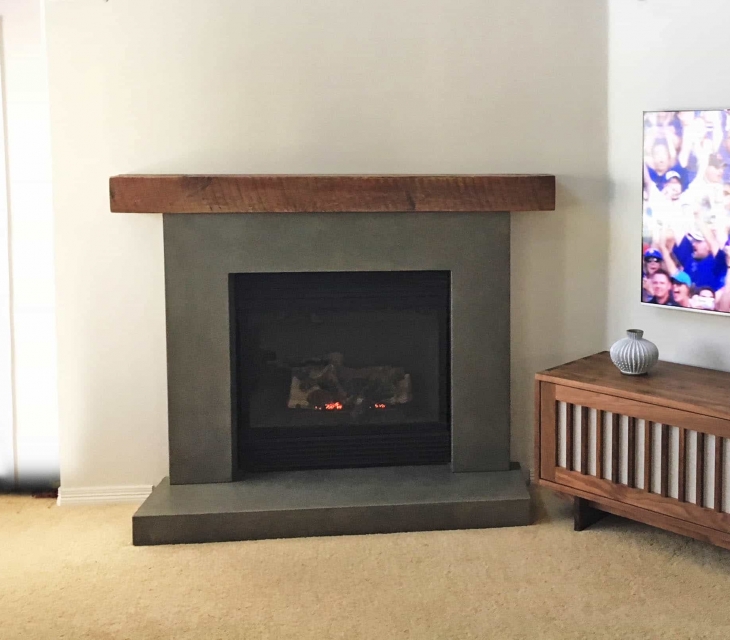 Reclaimed wood and concrete fireplace surround